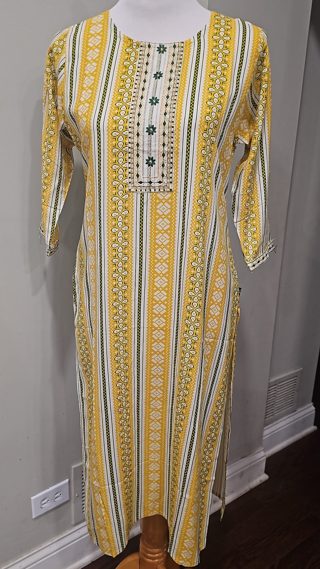 Yellow and cream striped kurti with green accents and an embroidered yoke