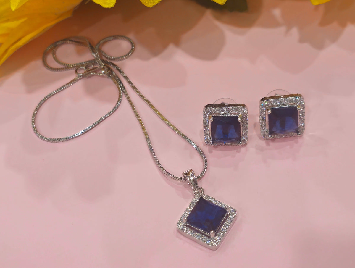 square halo pendant and two studs in blue.