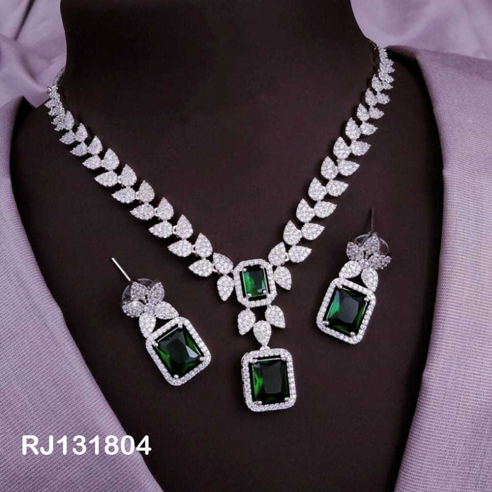 leafy design with green rectangular stones and matching two earrings.