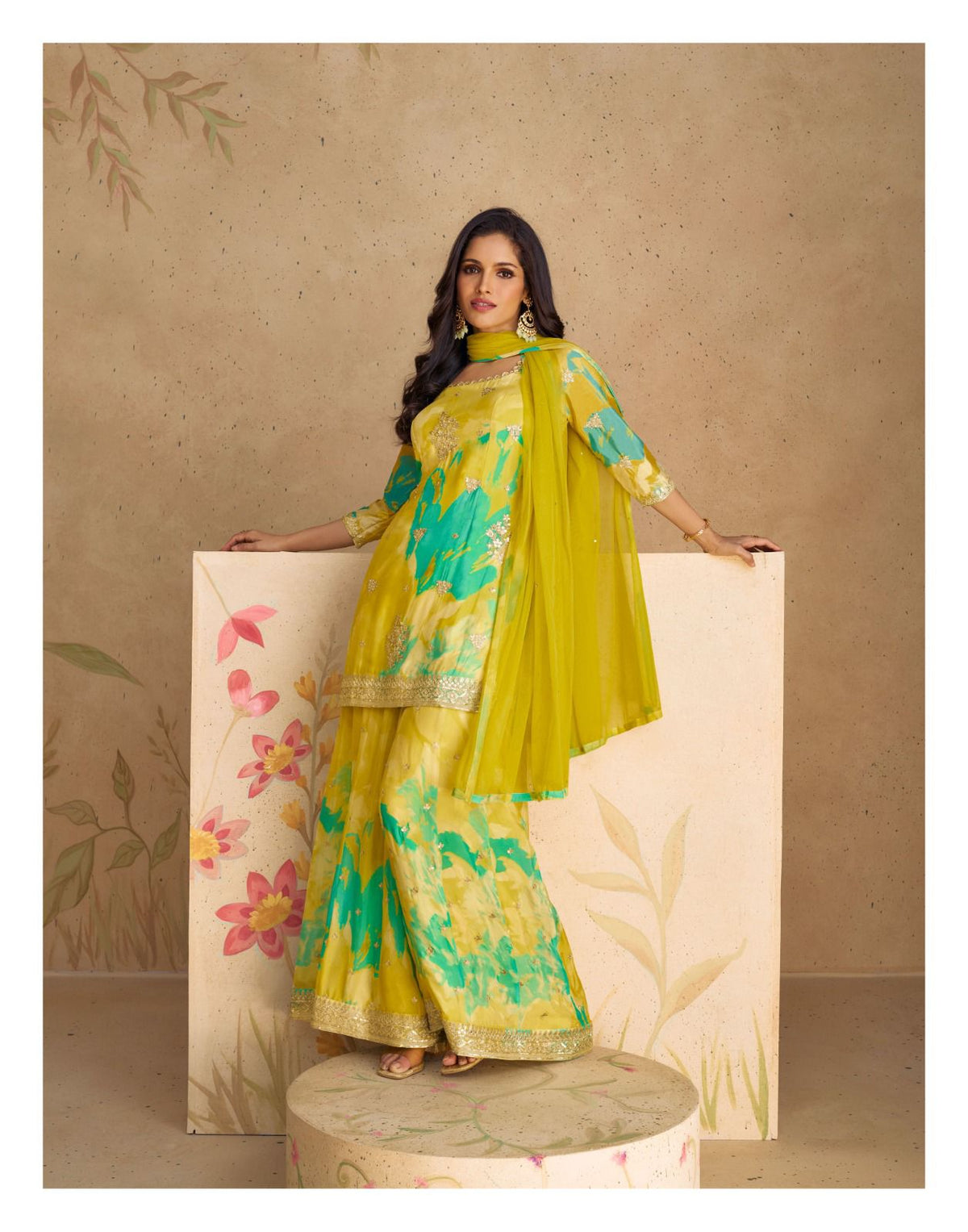 Yellow-green and teal floral tunic with printed flared trousers and green drape.