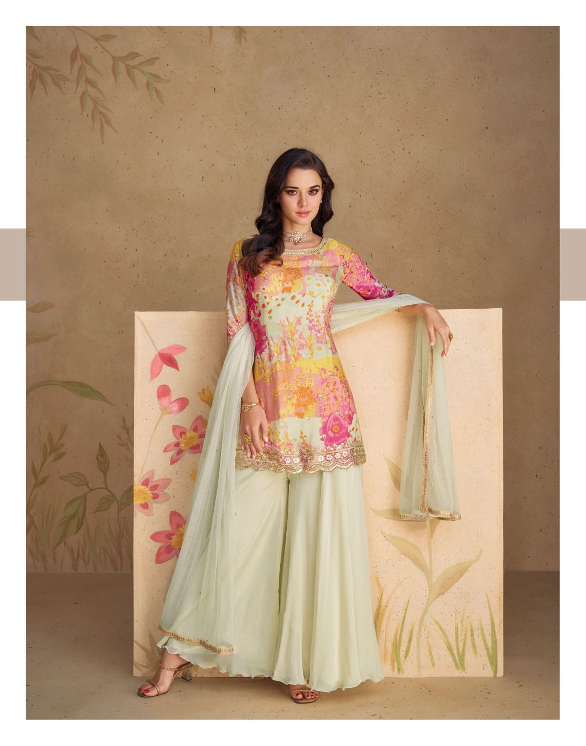 Cream/pale mint flared trousers and drape with multicolor floral tunic.