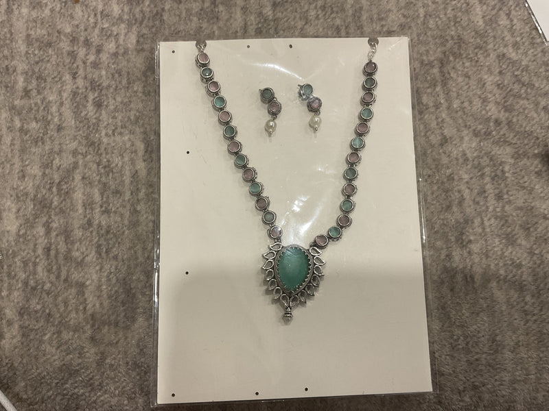 Mint-green and baby-pink necklace with round silver-tone links, a green teardrop pendant and matching earrings.