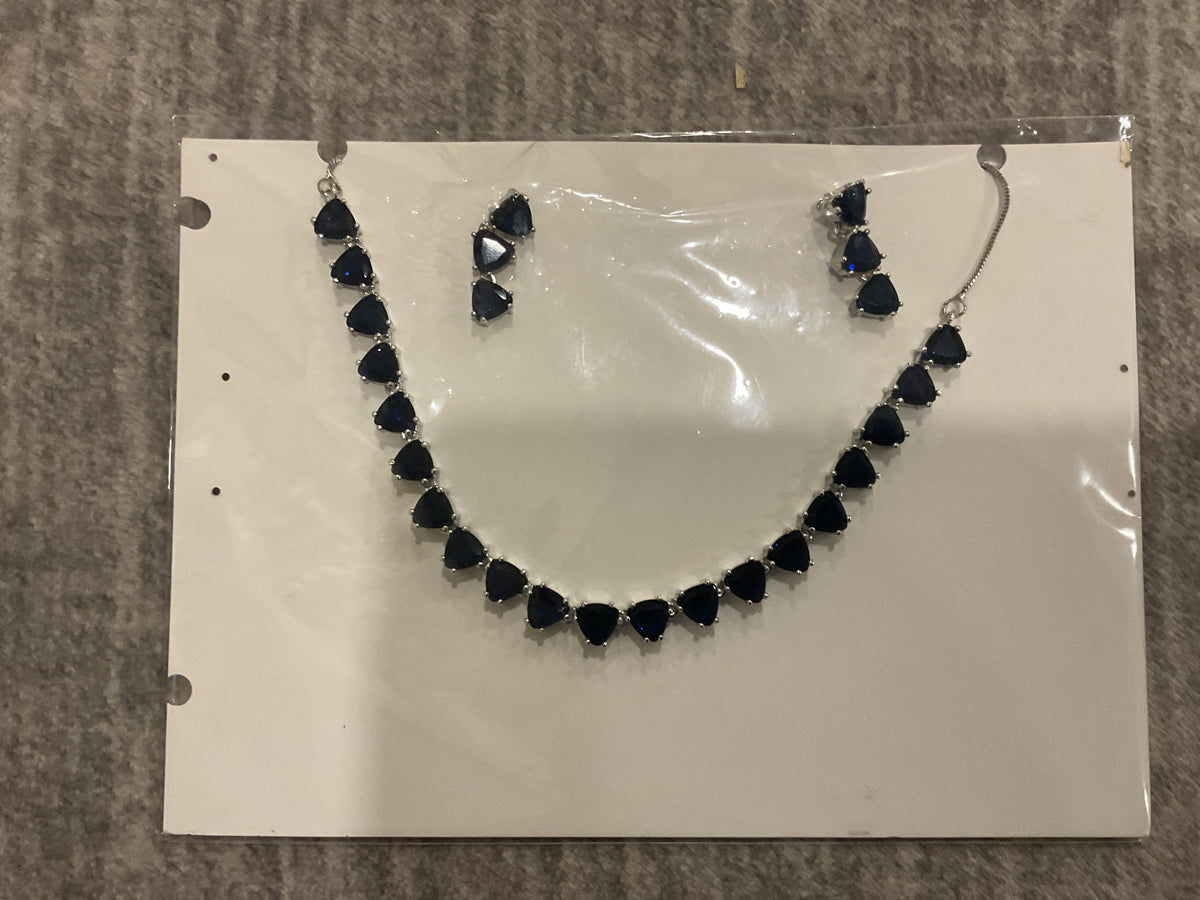 Navy-blue necklace with linked rounded triangular accents, silver-tone connectors and matching photographed drop earrings.