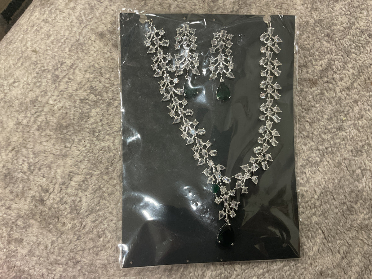 Dark-green teardrop necklace with branching silver-tone leaf-like clusters, clear accents and matching photographed drop earrings.