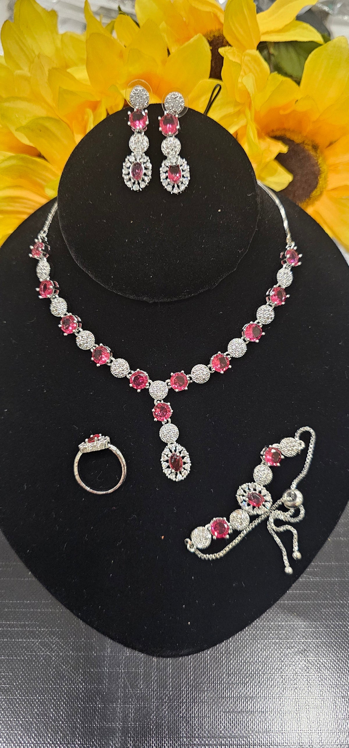 Rani pink (fuchsia) necklace with alternating colored centers and clear clusters with a central drop, shown with coordinating jewelry.