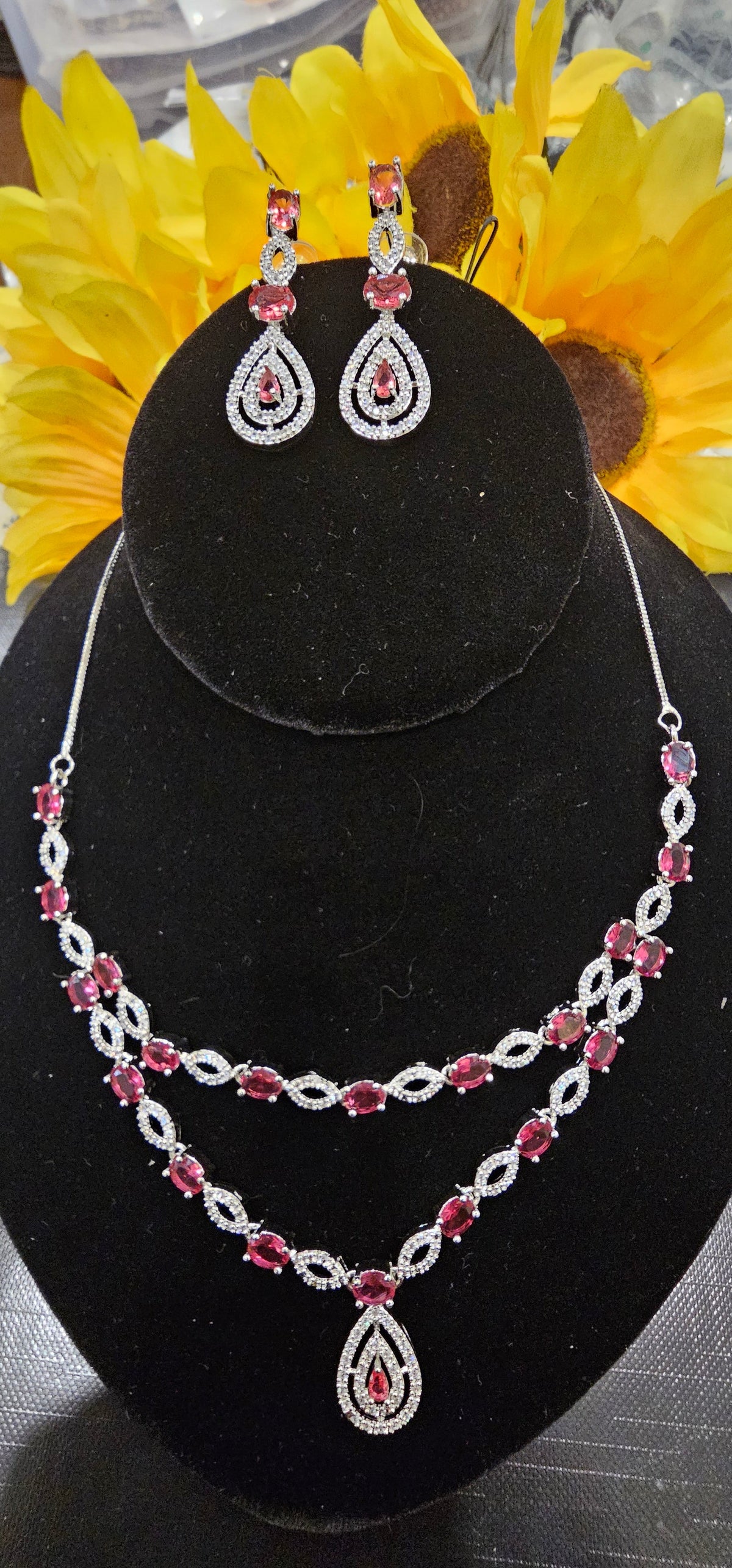 Rani pink (fuchsia) necklace with two layers of oval colored accents and open marquise-shaped links with a teardrop pendant, shown with coordinating jewelry.