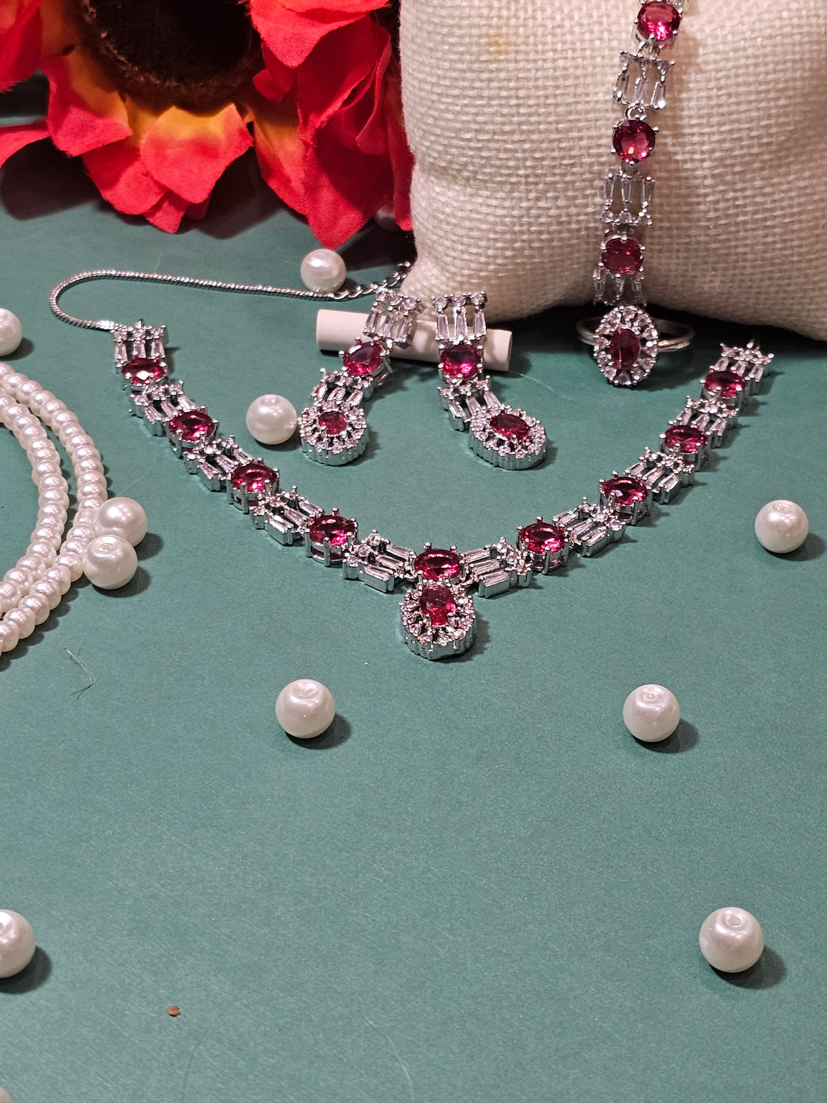 Rani pink (fuchsia) necklace with oval colored centers, clear rectangular accents and a central oval drop, shown with coordinating jewelry.