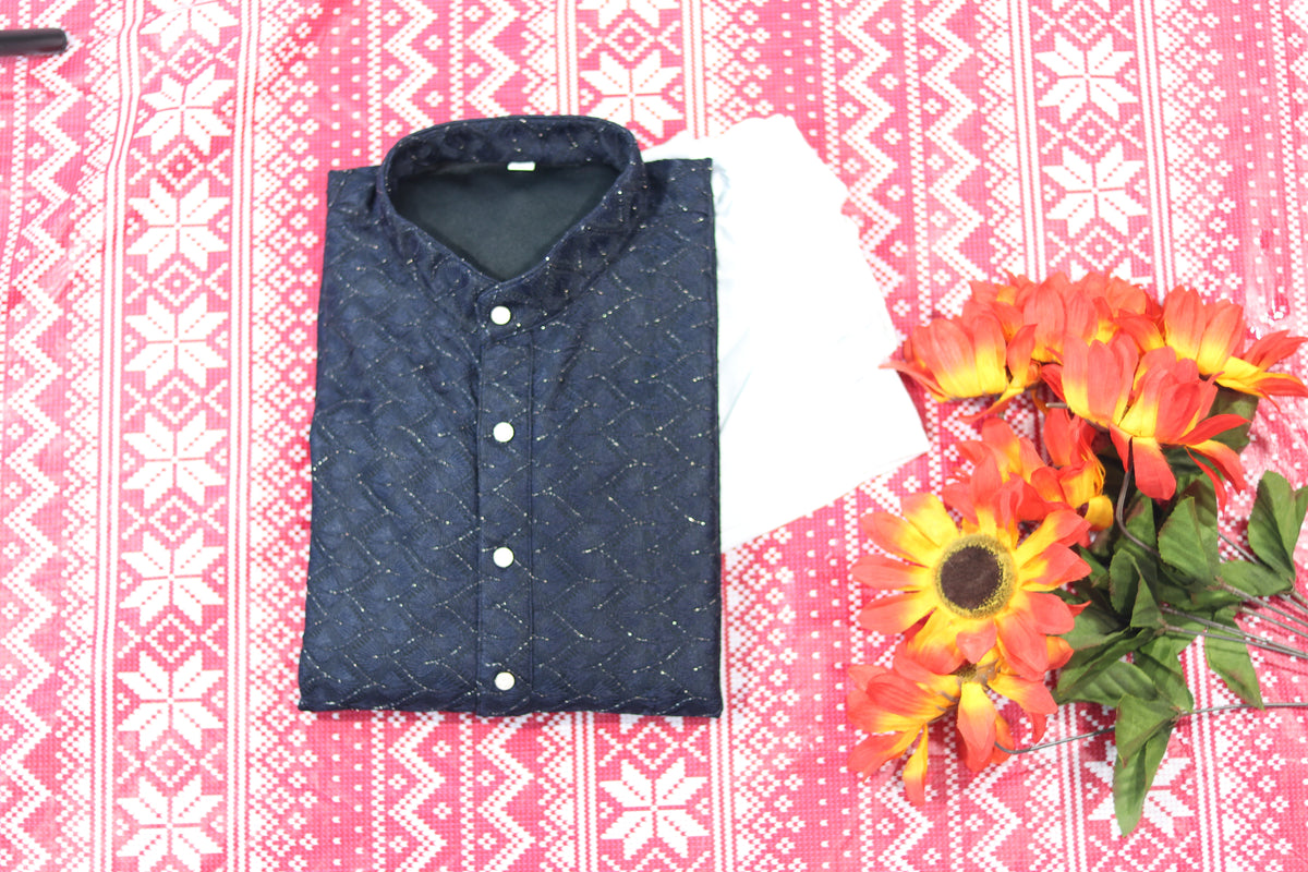 Folded navy blue kurta with fine diamond lines, a band collar and front buttons, arranged beside white fabric and decorative flowers.