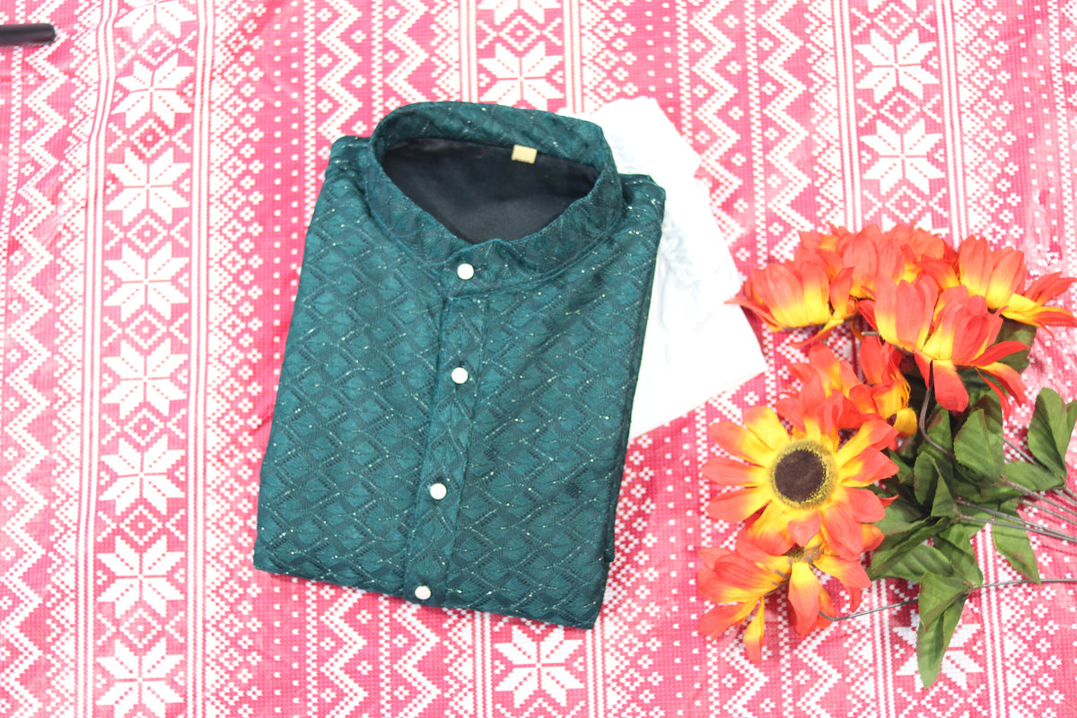 Folded teal green kurta with fine diamond lines, a band collar and front buttons, arranged beside white fabric and decorative flowers.