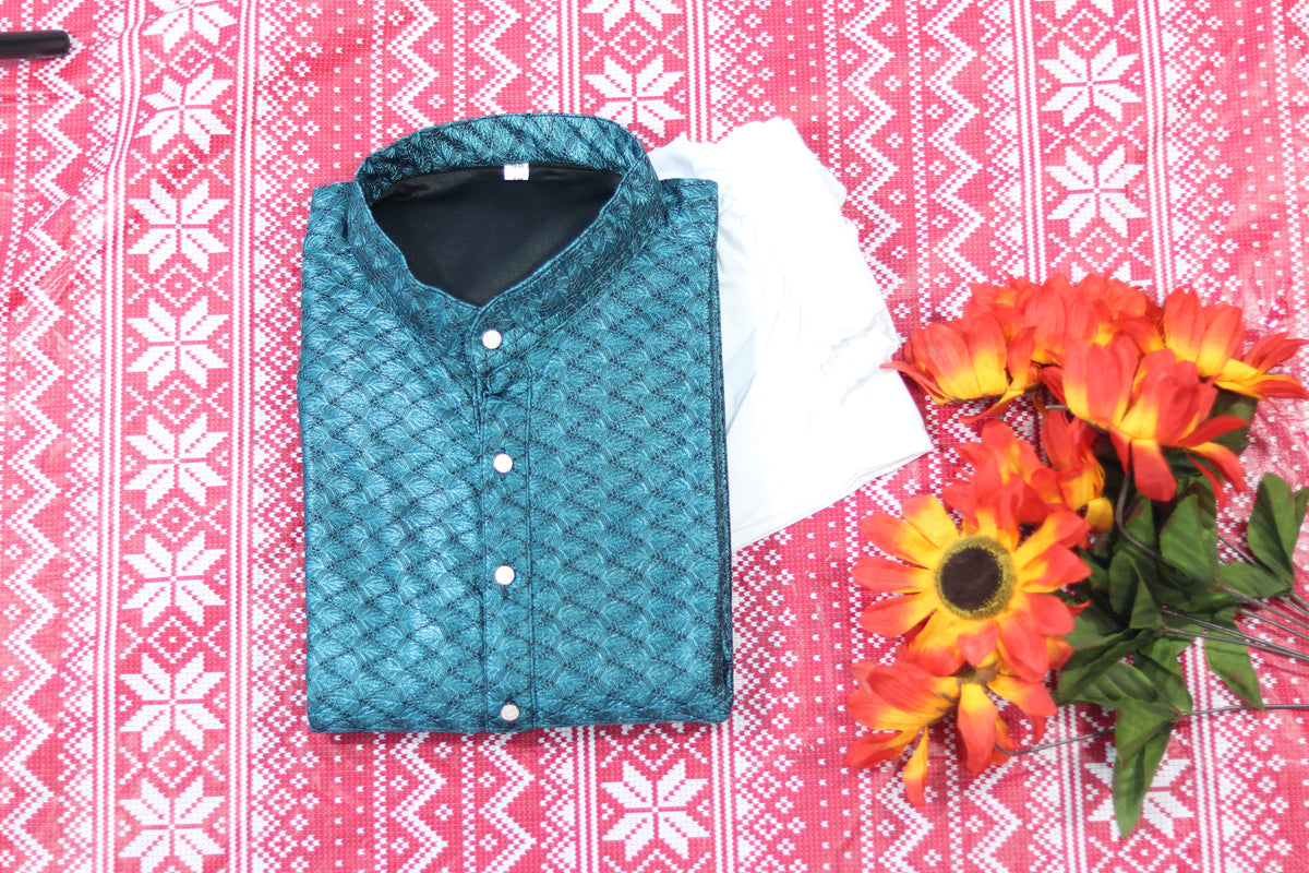 Folded teal blue kurta with textured diamond pattern, a band collar and front buttons, arranged beside white fabric and decorative flowers.