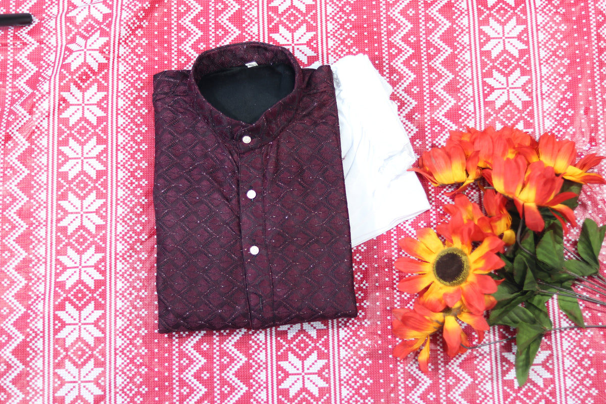 Folded wine kurta with fine diamond lines, a band collar and front buttons, arranged beside white fabric and decorative flowers.