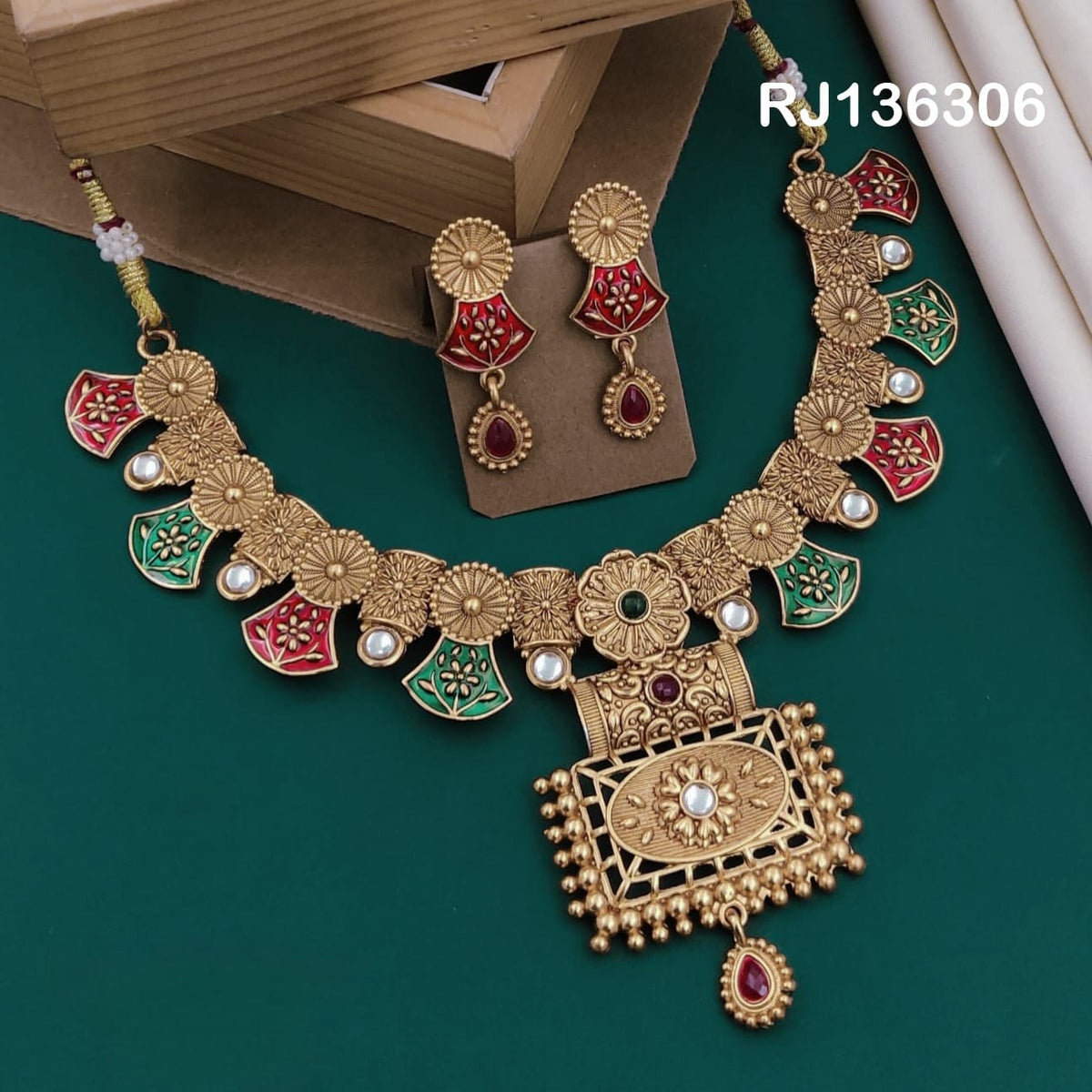 Antique gold-tone necklace with red and green fan-shaped motifs, flower links and a framed rectangular pendant, shown with coordinating drop earrings.