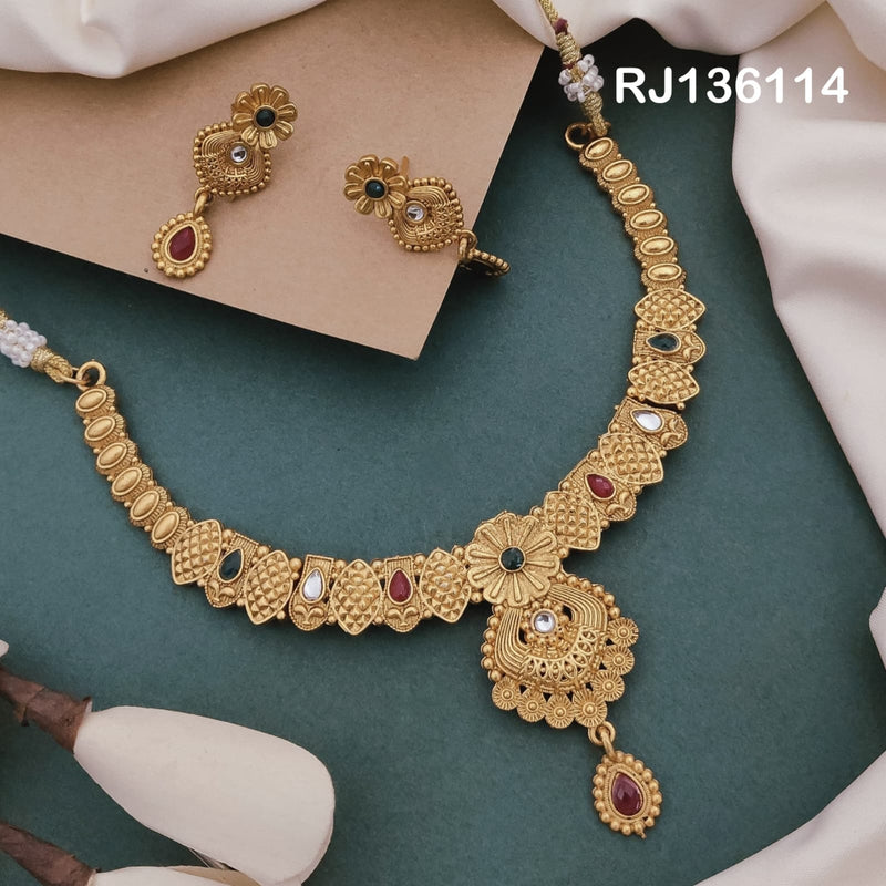 Antique gold-tone necklace with lattice-patterned leaf links, colored accents and an ornate pendant with a red drop, shown with coordinating drop earrings.